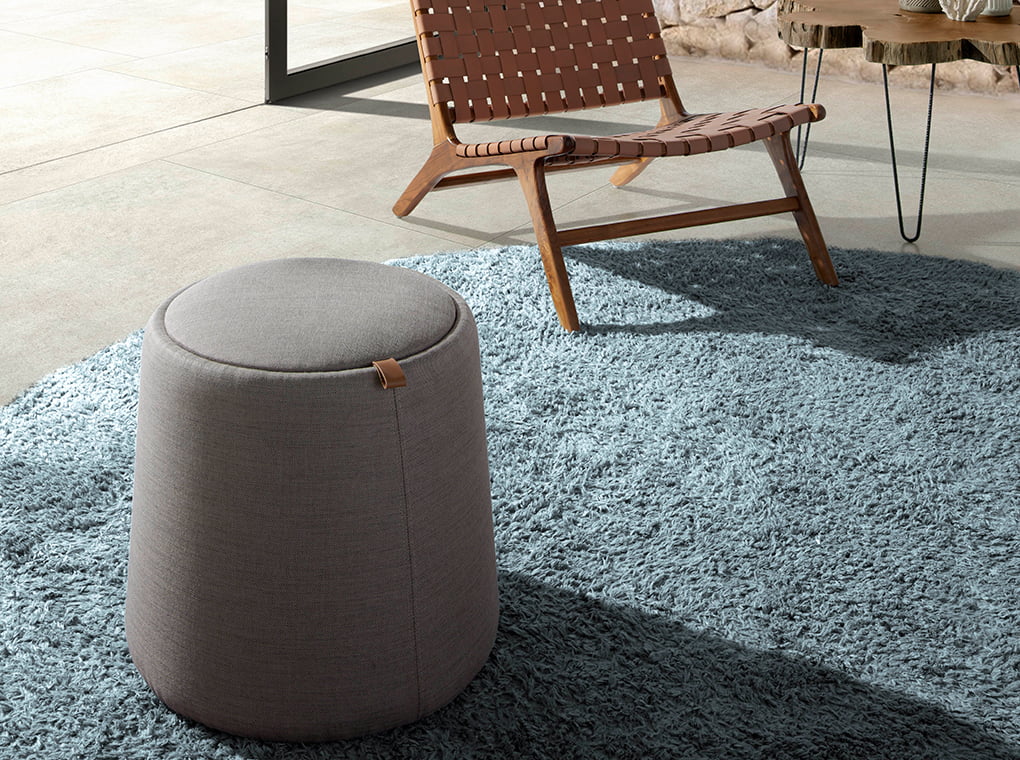 Puff upholstered in gray fabric