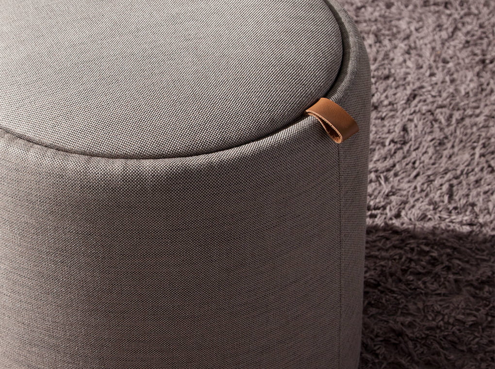 Puff upholstered in gray fabric